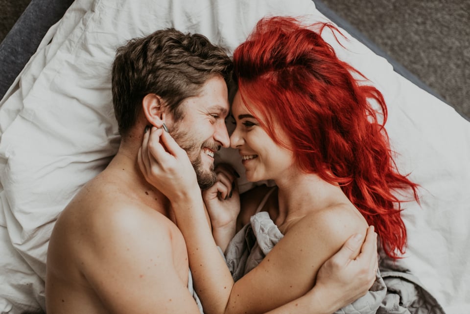 Couple in bed showing happiness