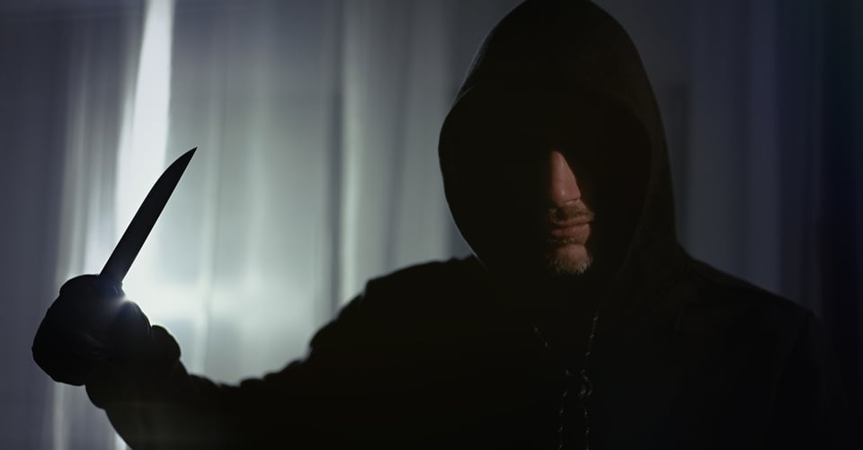 A killer with a knife inside a house