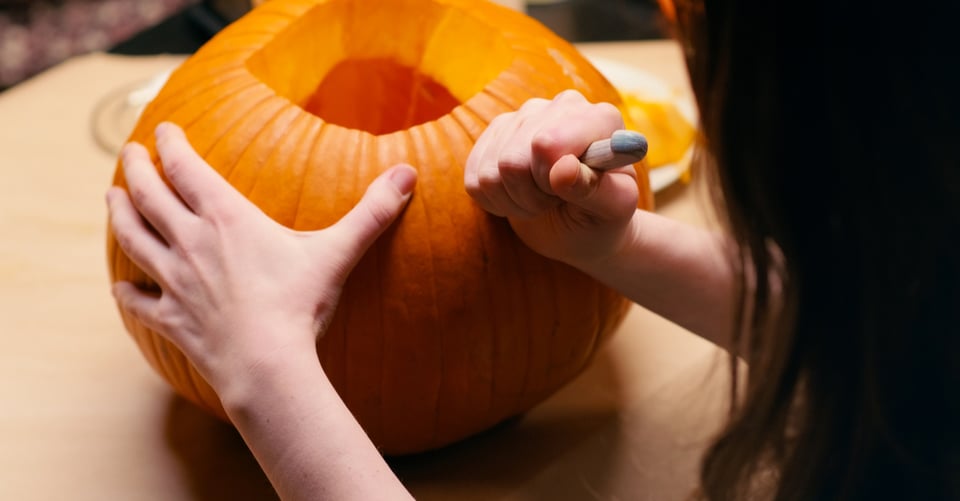 Person carving pumpkin